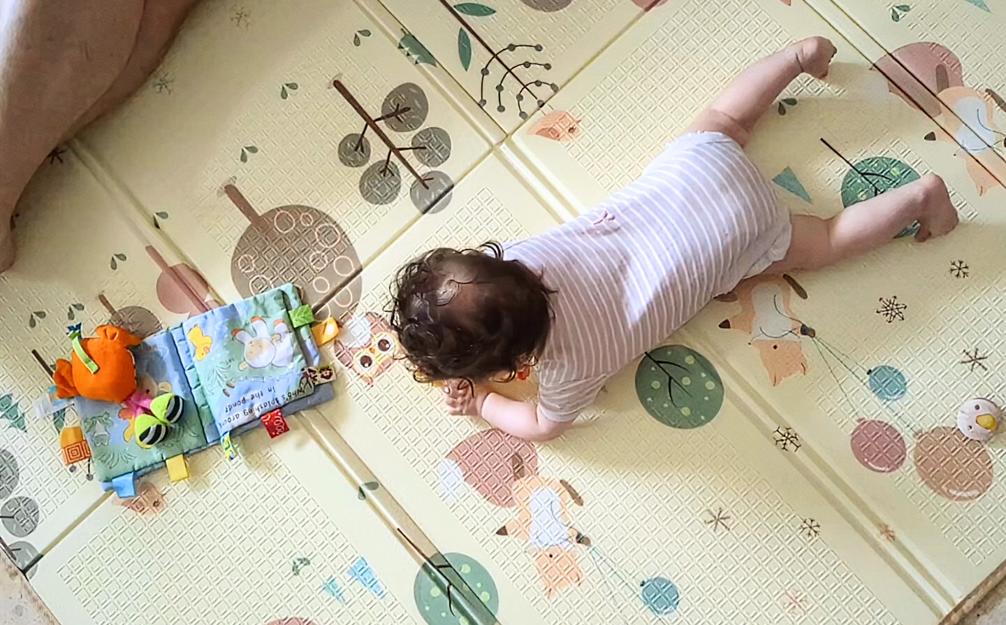 תינוק משחק ונע על הרצפה בסביבה שמאפשרת חקירה והתנסות